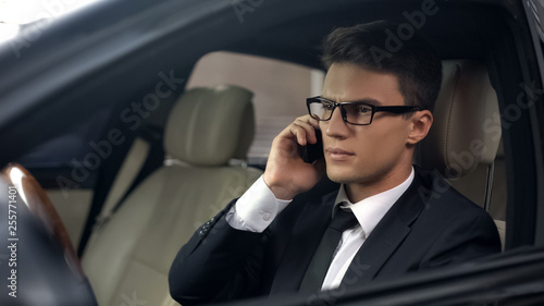 Upset politician talking on phone, sitting in car, business trip, travelling © motortion