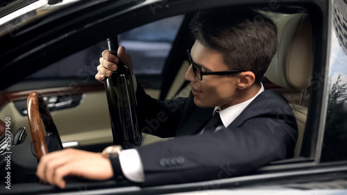 Businessman drinks alcohol before car driving, accident risk, irresponsibility