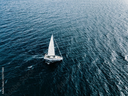 Aerial view of Sailing ship yachts with white sails  in deep blue sea