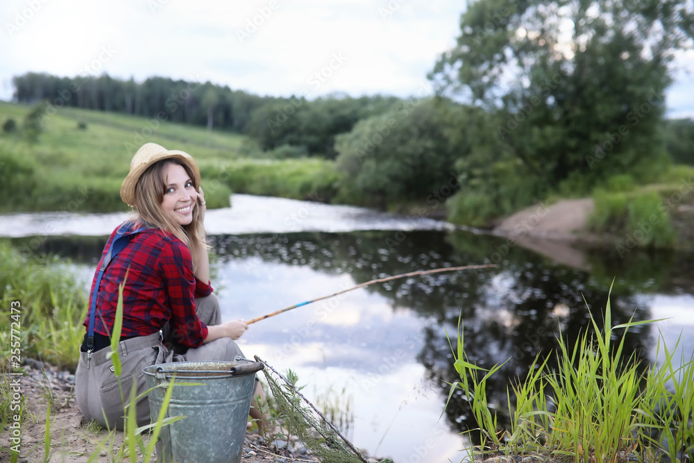 Girl by the river with a fishing rod Girl by the river with a fishing rod