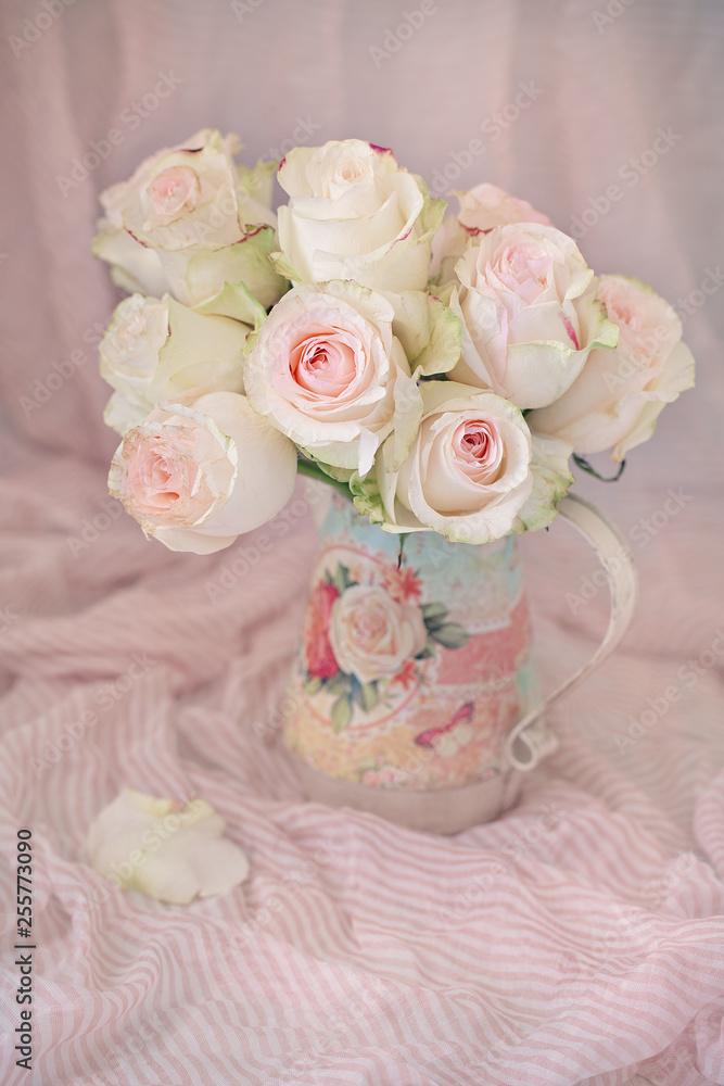 Close-up floral composition with a pink roses .Many beautiful fresh pink roses in a jug on a table. Close-up floral composition with a pink roses .Many beautiful fresh pink roses in a jug on a table.