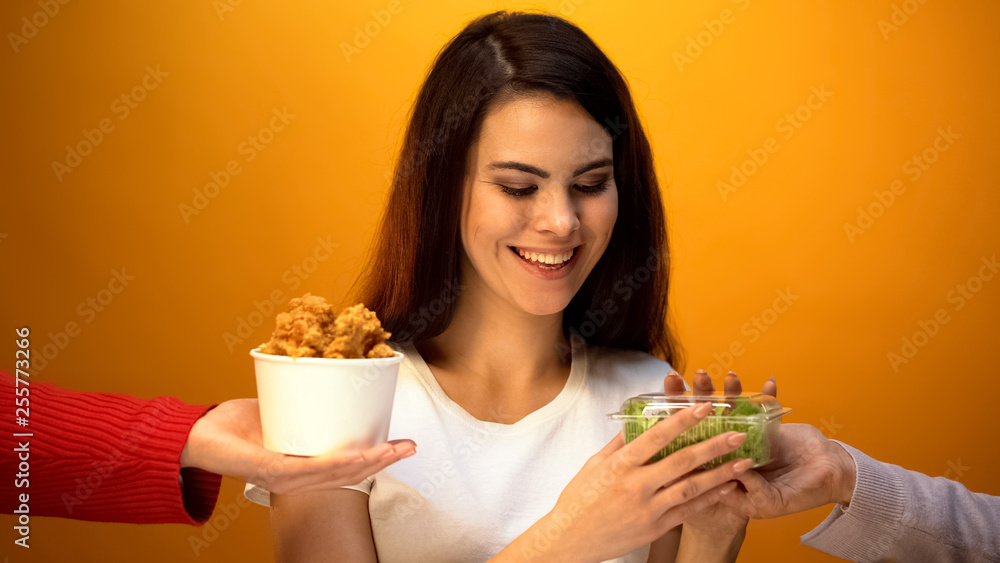 Girl choosing salad instead of fried meat, healthy food for weightloss, diet Girl choosing salad instead of fried meat, healthy food for weightloss, diet