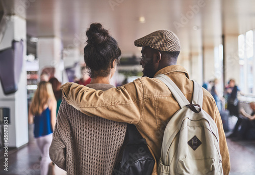 Rear view of a loving couple walking along the railway station © Yakobchuk Olena