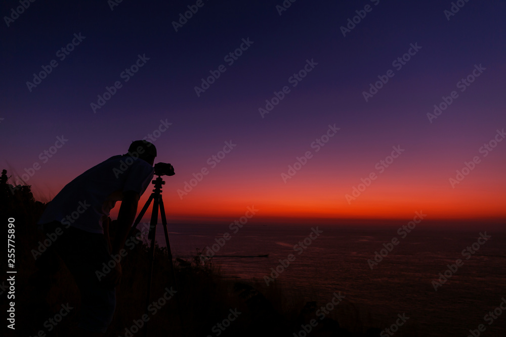 Professional photography man take a photo sunset or sunrise dramatic sky over the tropical sea in phuket thailand