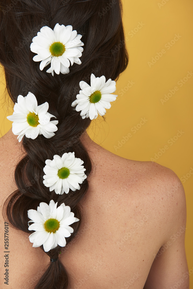 Graceful brunette woman with camomiles in hair Graceful brunette woman with camomiles in hair