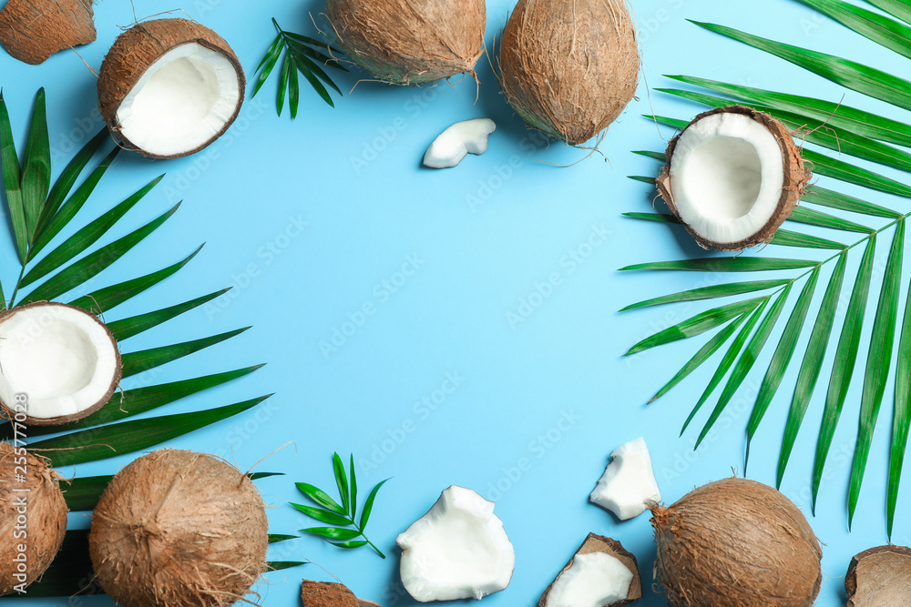 Tropical coconuts with palm branches on color background, space for text Tropical coconuts with palm branches on color background, space for text