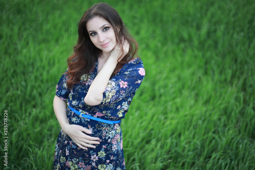 Pregnant girl in a dress in nature Pregnant girl in a dress in nature