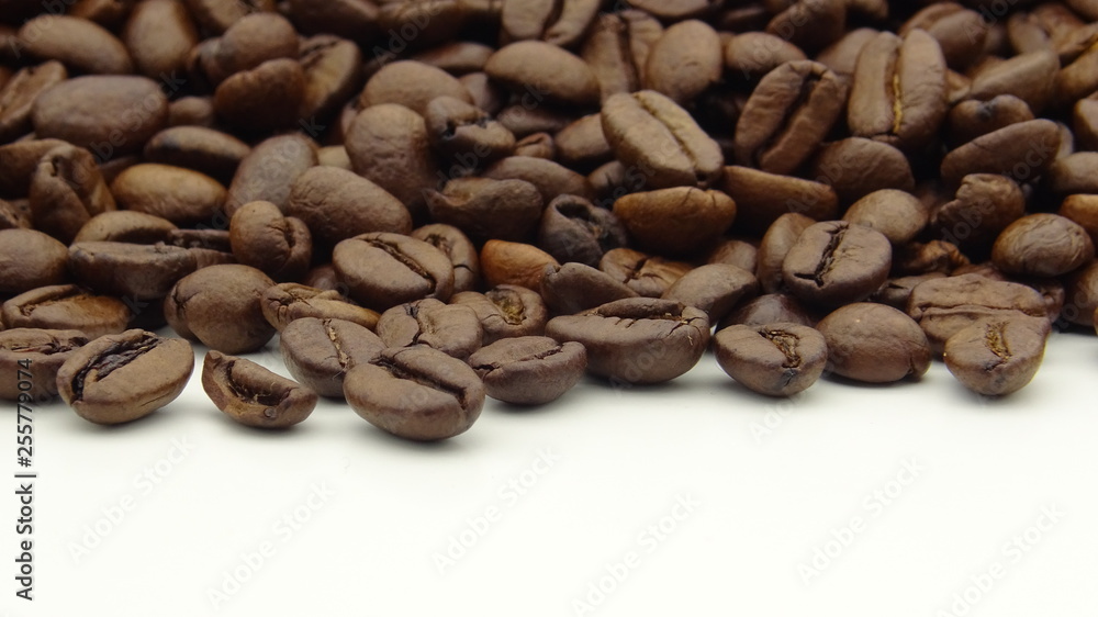Close up of roasted coffee beans on white background Close up of roasted coffee beans on white background