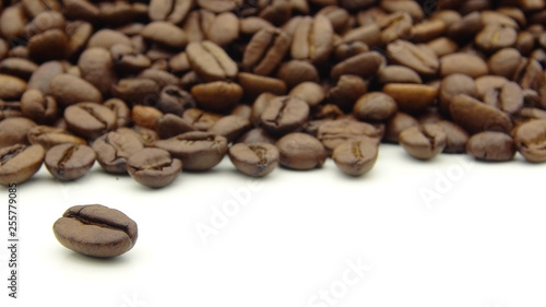 Close up of roasted coffee beans on white background