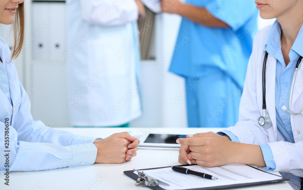 Doctor and patient discussing something, just hands at the table, white background Doctor and patient discussing something, just hands at the table, white background