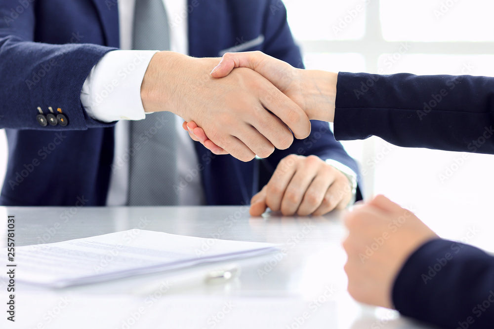 Group of business people or lawyers shaking hands finishing up a meeting , close-up. Success at negotiation and handshake concepts
