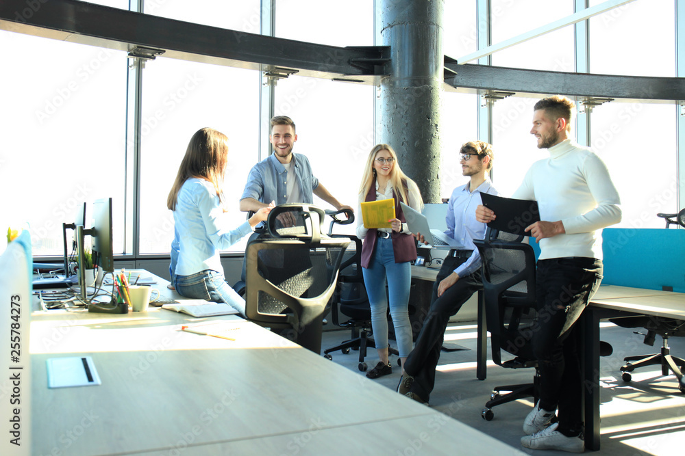 Young colleagues in smart casual wear working while spending time in the office. Young colleagues in smart casual wear working while spending time in the office.