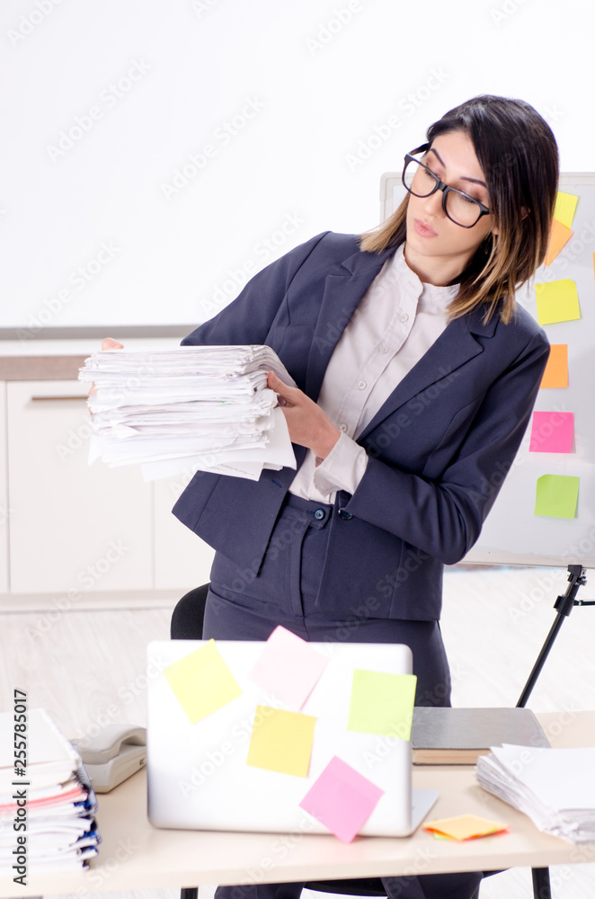 Young female employee in conflicting priorities concept Young female employee in conflicting priorities concept