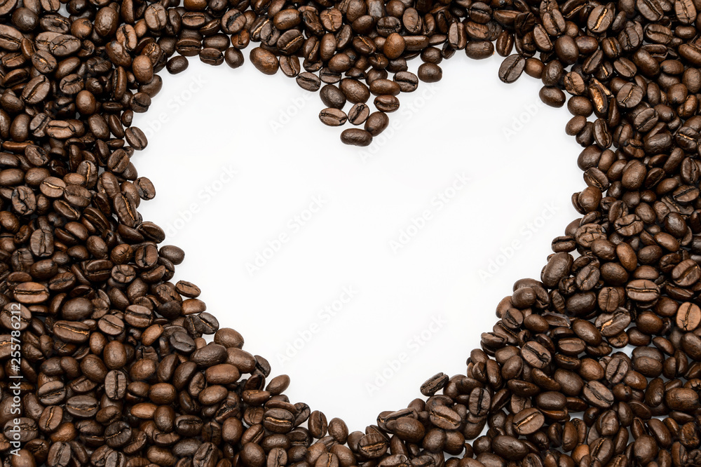Roasted coffee beans background in the shape of heart Roasted coffee beans background in the shape of heart