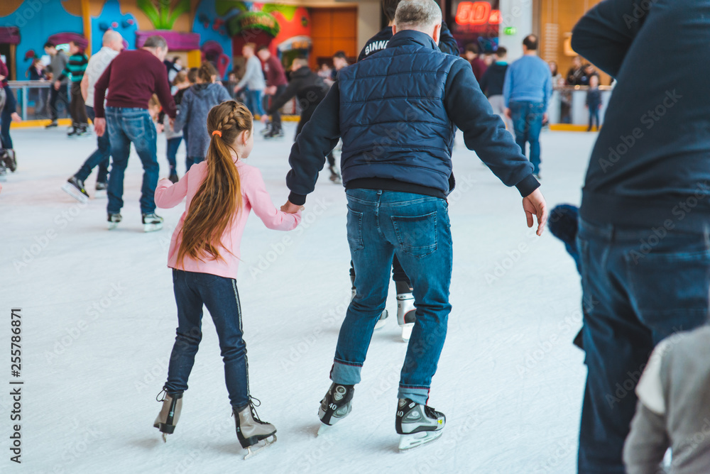 LVIV, UKRAINE - February 3, 2019: people skating on ski rink in city mall