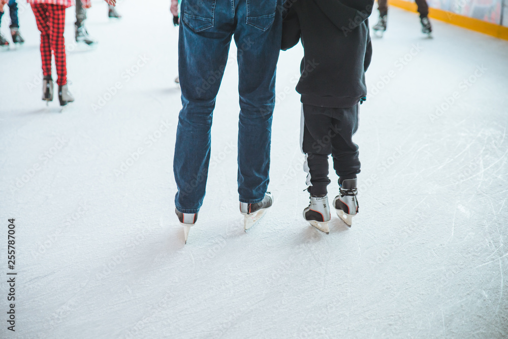 LVIV, UKRAINE - February 3, 2019: people skating on ski rink in city mall LVIV, UKRAINE - February 3, 2019: people skating on ski rink in city mall