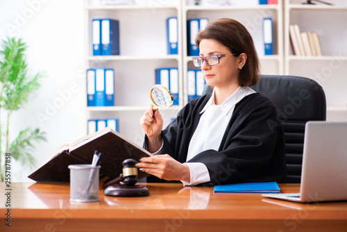 Middle-aged female doctor working in courthouse 