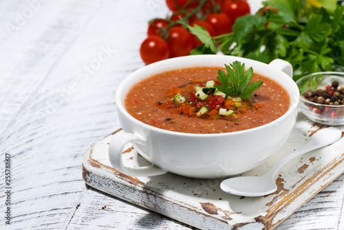 cold tomato soup in a bowl on white background