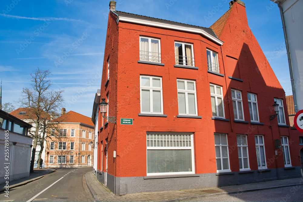 BRUGES, BELGIUM - FEBRUARY 17, 2019: red brick house on a street in the city