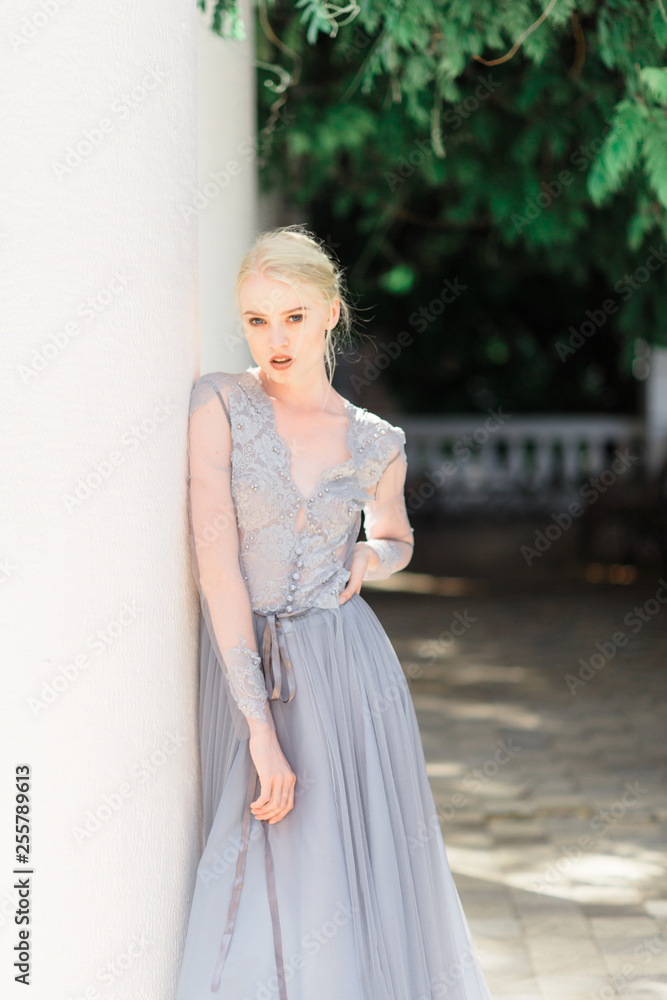 Stunning bride in beautiful wedding dress on natural background.