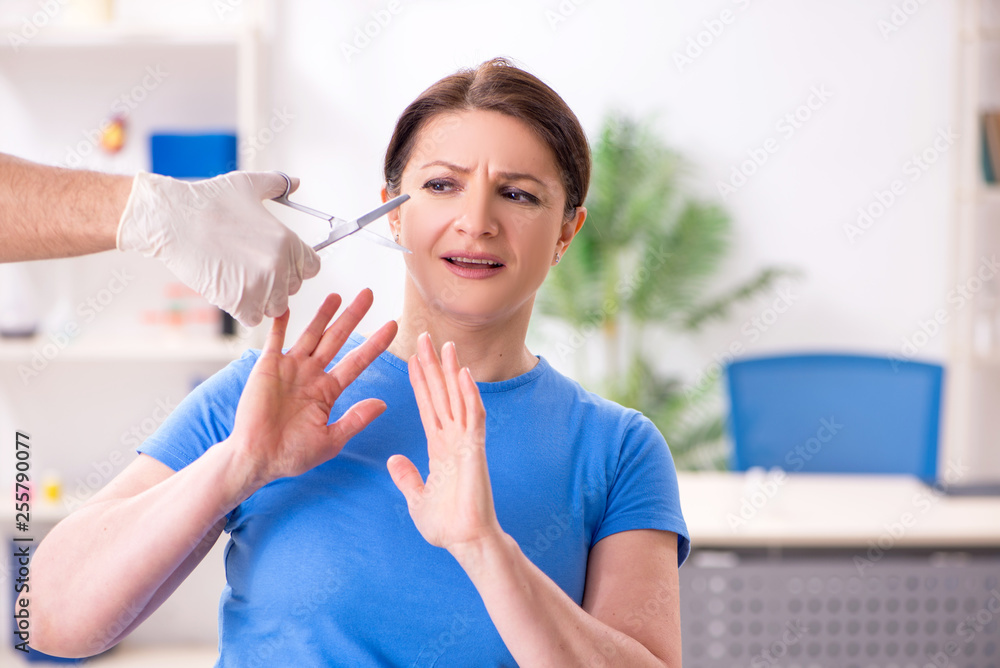 Woman visiting male doctor for plastic surgery Woman visiting male doctor for plastic surgery