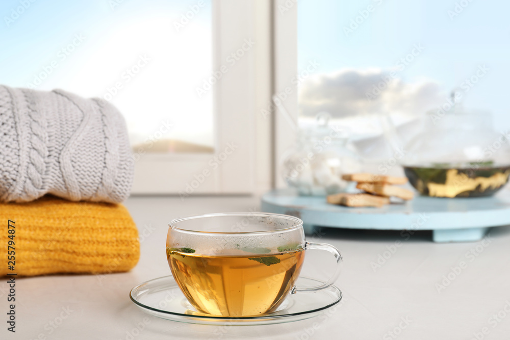 Composition with cup of hot winter drink on windowsill Composition with cup of hot winter drink on windowsill