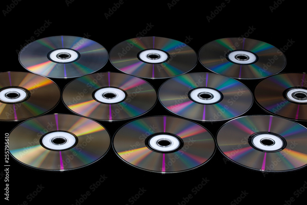 Compact discs on a black background with color reflection Compact discs on a black background with color reflection