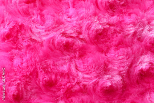 Texture of fuzzy pink fabric as background, closeup