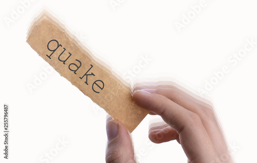  Quake word on torn notepaper in hand photo