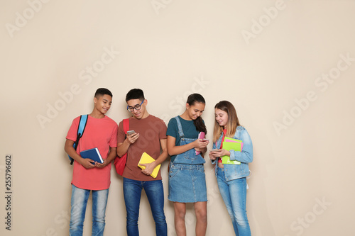 Group of teenagers on color background. Youth lifestyle and friendship