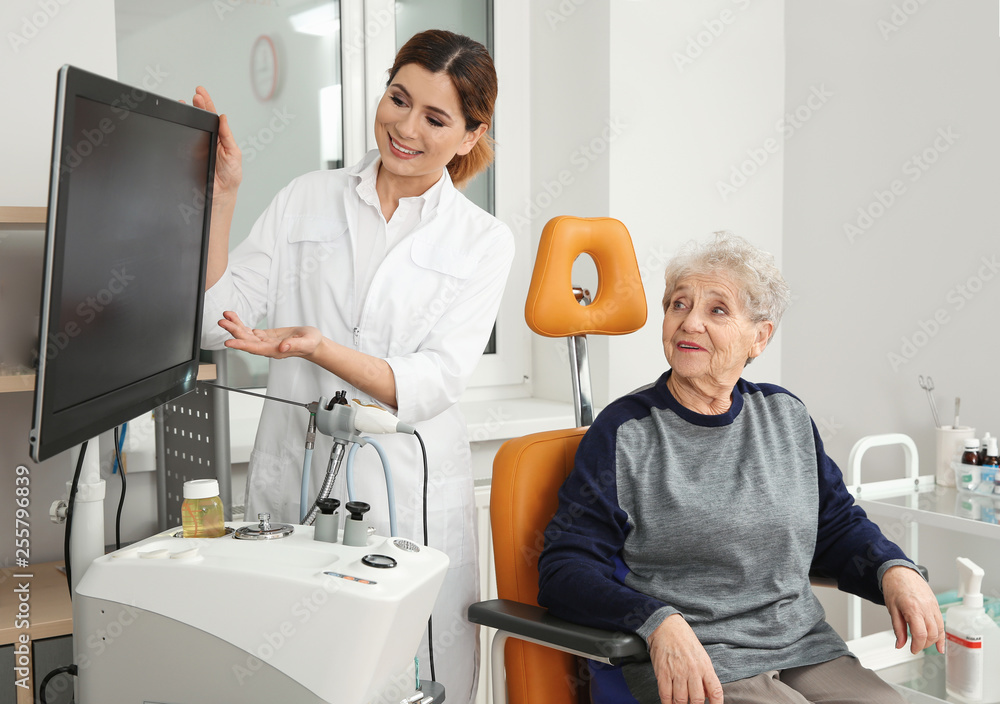 Senior woman visiting professional otolaryngologist in clinic. Hearing disorder Senior woman visiting professional otolaryngologist in clinic. Hearing disorder