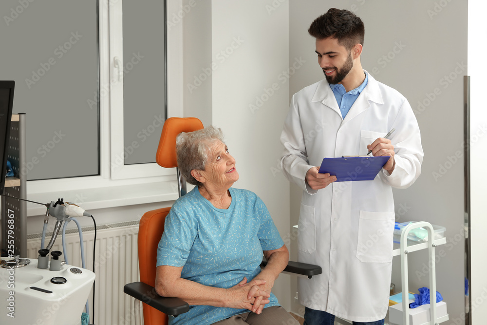 Fototapeta premium Senior woman visiting otolaryngologist in clinic. Hearing aid