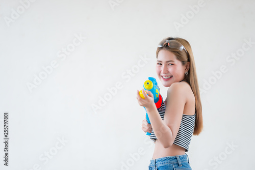 Asian sexy woman with gun water in hand on white background,Festival songkran day at thailand,The best of festival of thai,Land of smile