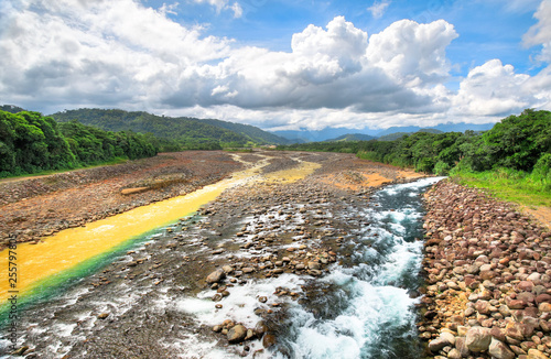 A clean stream converges with the Rio Sucio near Guapiles, Costa Rica. photo
