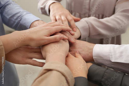 Group of people holding their hands together, closeup