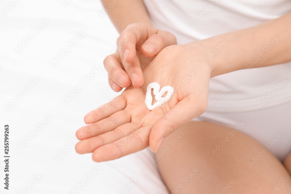 Young woman with heart made of cream on her hand, closeup. Beauty and body care Young woman with heart made of cream on her hand, closeup. Beauty and body care