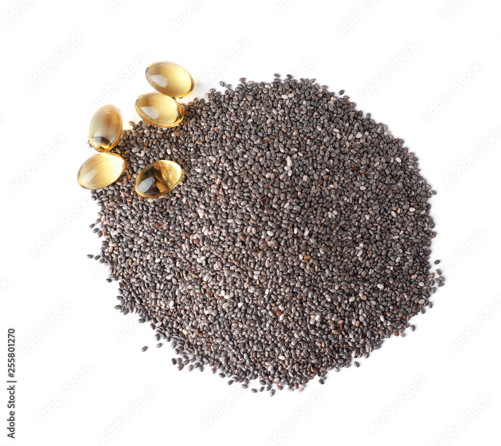 Pile of chia seeds and oil capsules isolated on white, top view