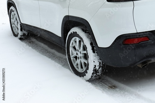 Modern car on snowy road, closeup view. Winter season