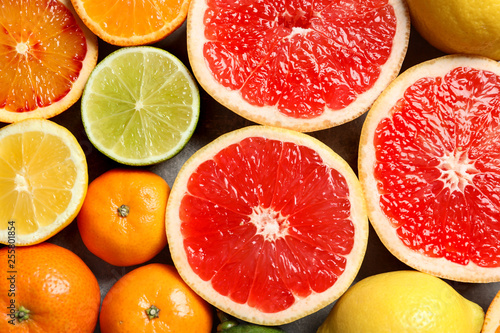 Different citrus fruits as background, top view