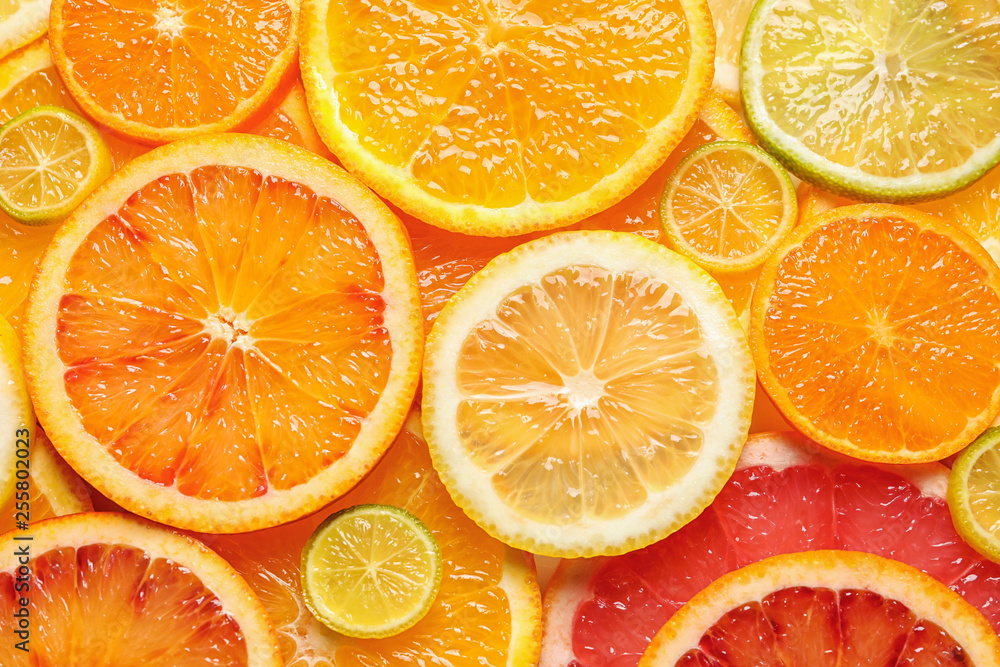 Slices of fresh citrus fruits as background, top view Slices of fresh citrus fruits as background, top view