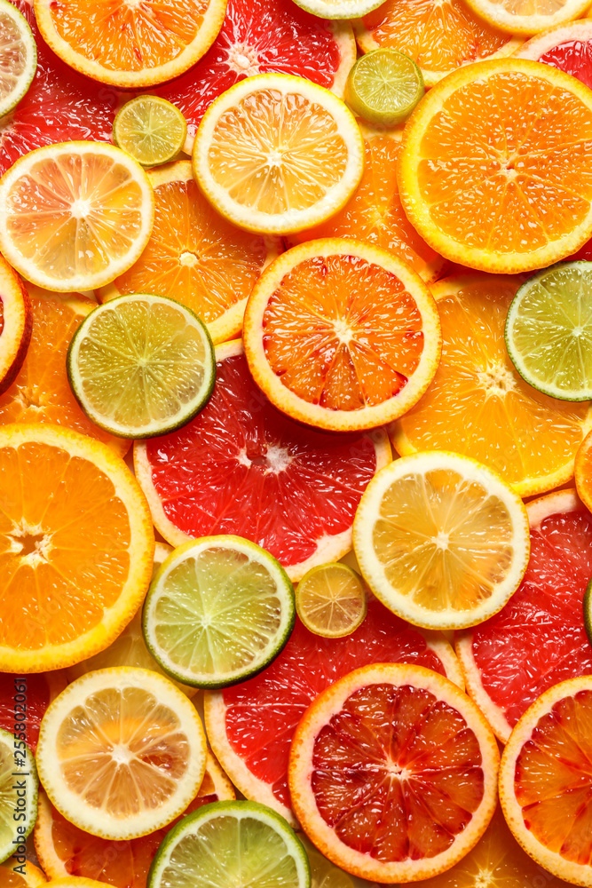 Slices of fresh citrus fruits as background, top view Slices of fresh citrus fruits as background, top view