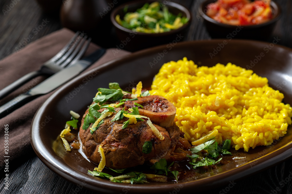 Braised veal shank, ossobuco, served with risotto and gremolata.