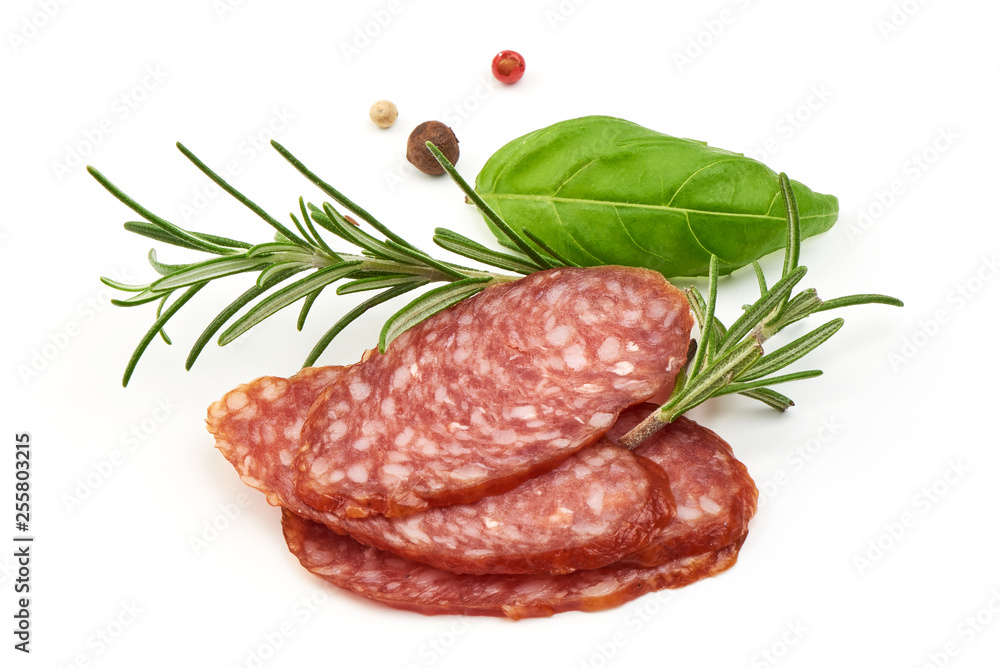 Dried salami slices with herbs, close-up, isolated on white background