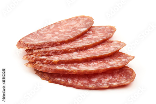 Dried salami slices, close-up, isolated on white background