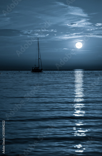 Beautiful night Adriatic sea, yacht and full moon, Croatia. Night seascape.