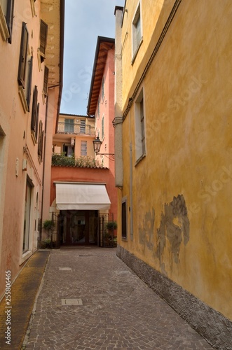 Narrow alley in Peschiera, Lake Garda, Italy © monysasi