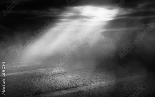 Background scene of empty street. Night view of the river, the night sky with clouds, a reflection of light on the asphalt. Smoke fog