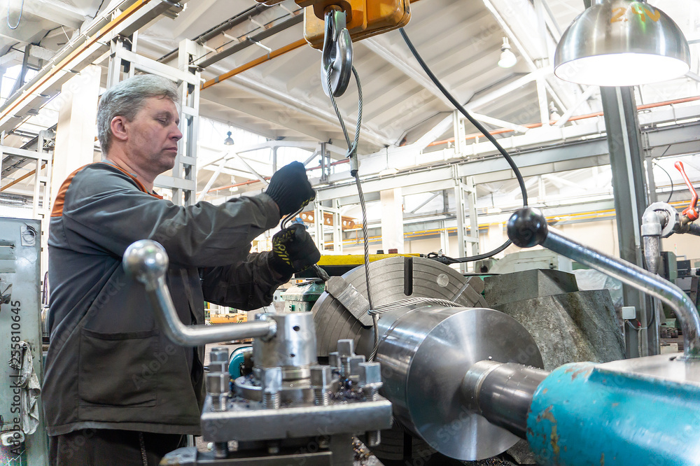 Turner worker manages the metalworking process of mechanical cutting on a lathe. Turner worker manages the metalworking process of mechanical cutting on a lathe.