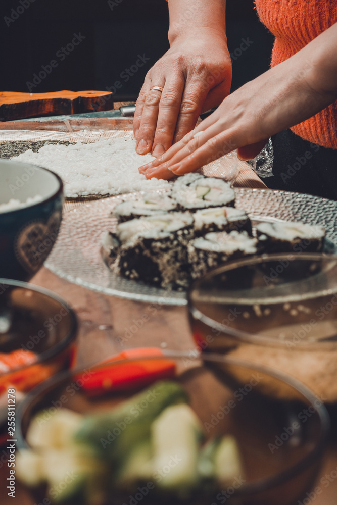 The process of preparing sushi from rice and additional ingredients at home
