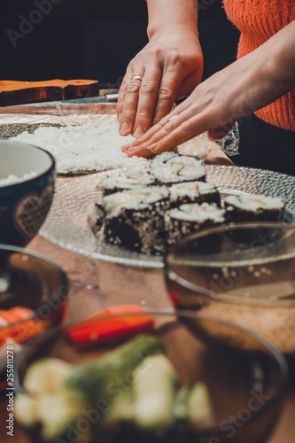 The process of preparing sushi from rice and additional ingredients at home